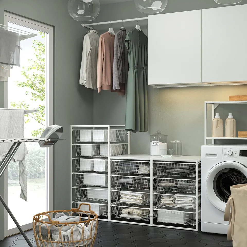 Modern laundry room with white JONAXEL storage system, sized well for space, holding clothes and supplies neatly.