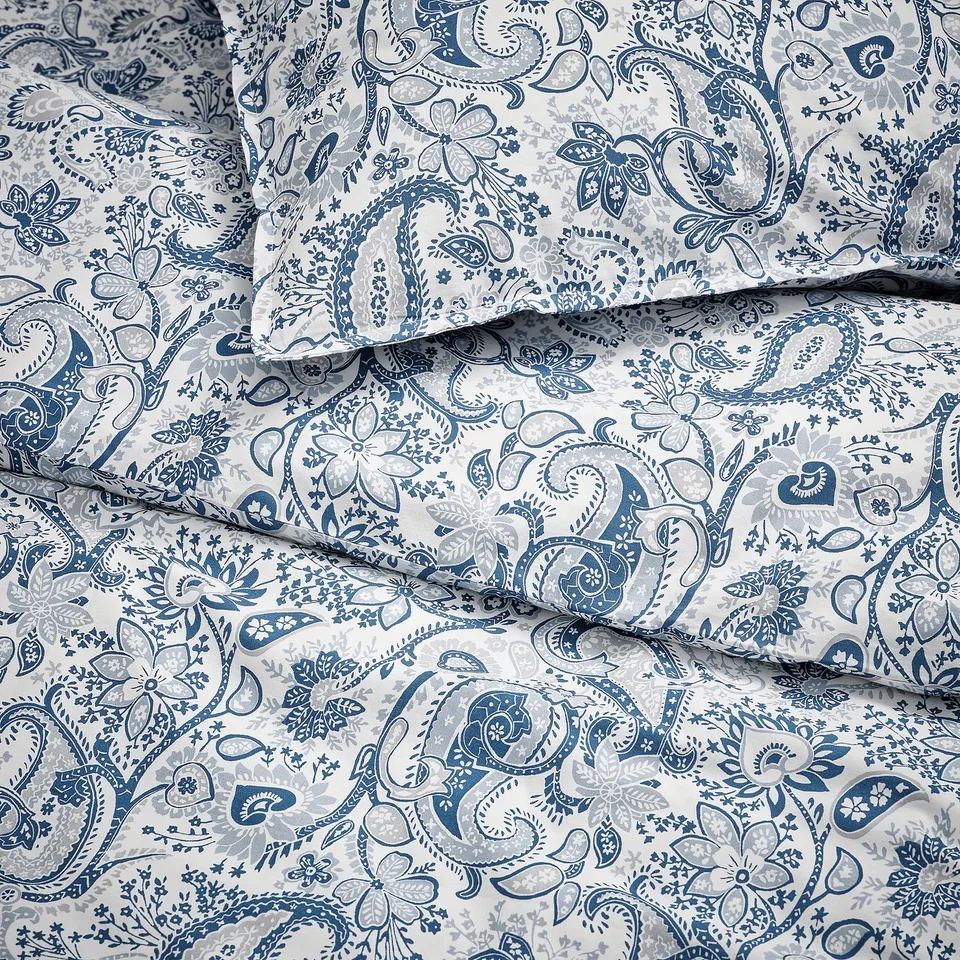 Paisley bedding with intricate blue patterns on light background. Soft, high-quality cotton-viscose blend, detailed floral designs.