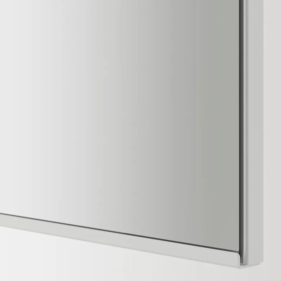 Mirrored cabinet door, polished edge detail, reflecting light, seamless connexion.