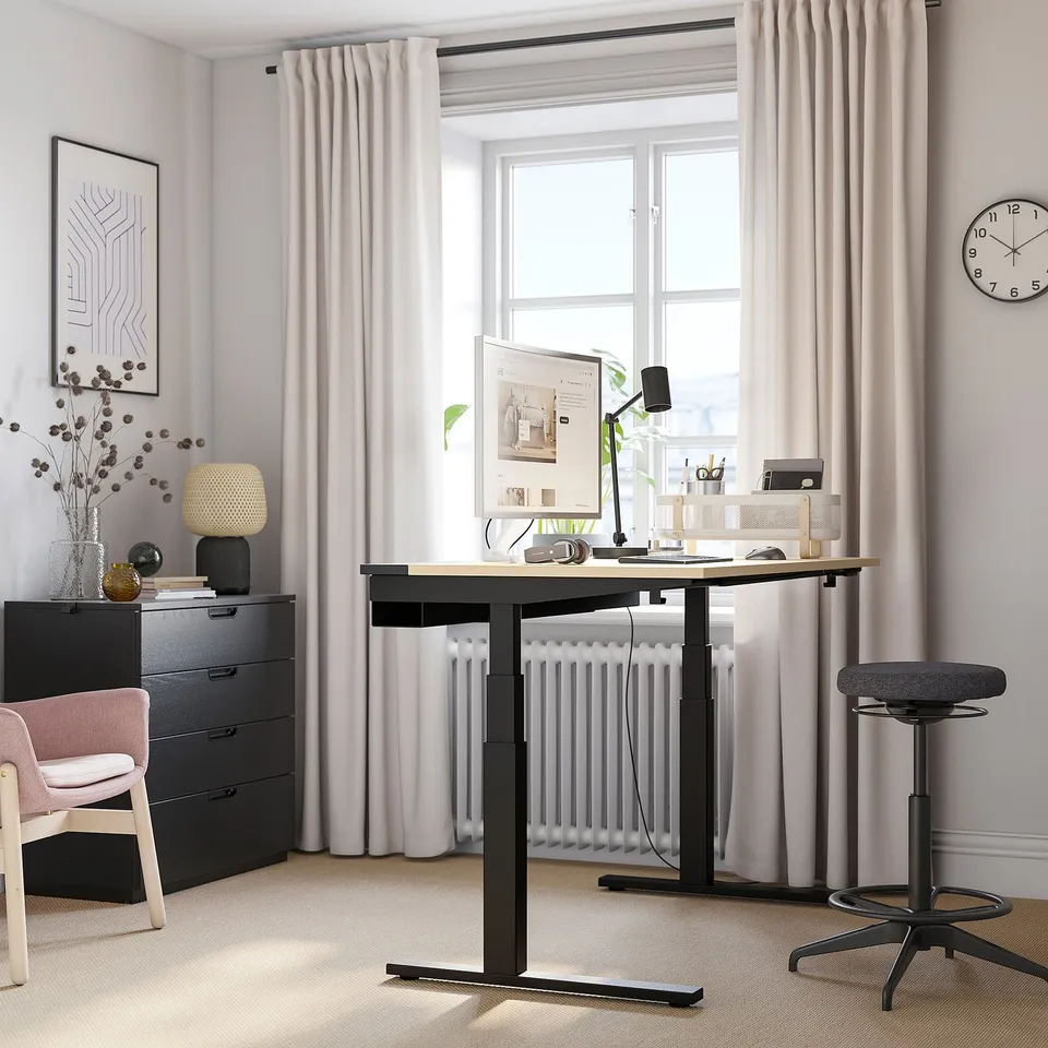 Home office setup with MITTZON black sit-stand desk, ergonomic chair, stylish decor. Clean design, efficient layout.