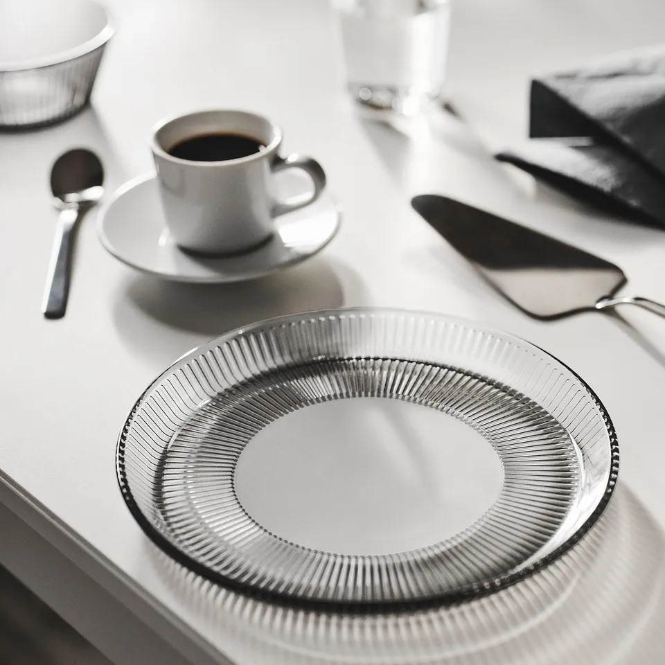 Grey HAVSGÄDDA side plate with vertical lines. Shown with coffee and utensils.