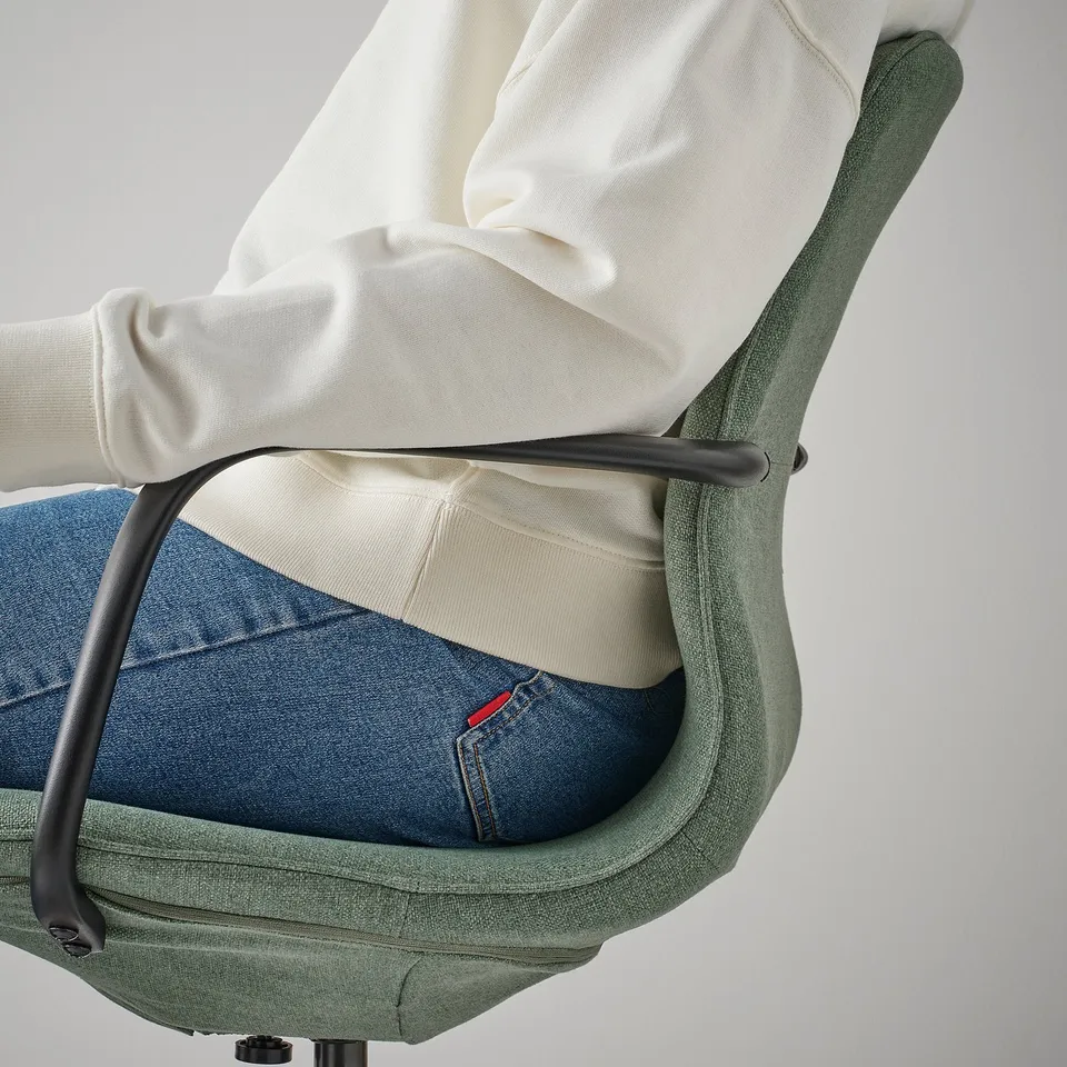 Person sitting on LÅNGFJÄLL office chair, showing height-adjustable seat and lumbar support for comfort.