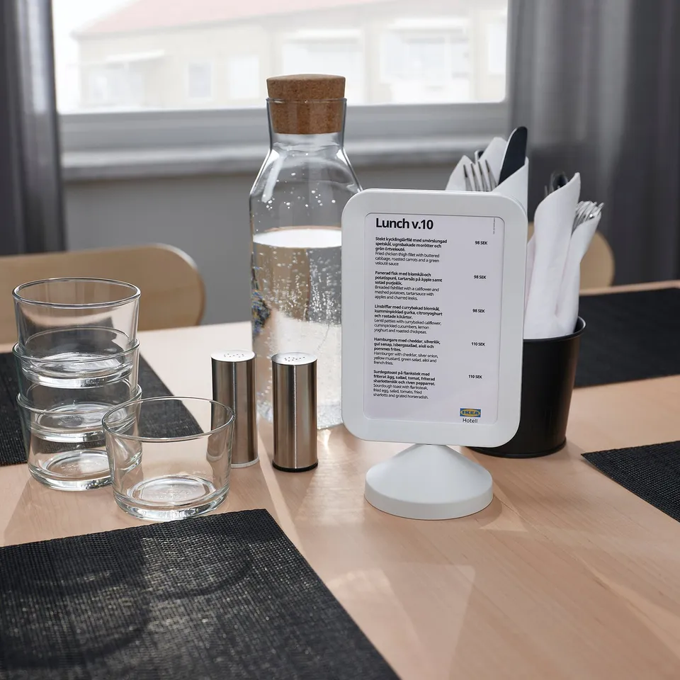 Menu stand displaying both sides with glasses and utensils.