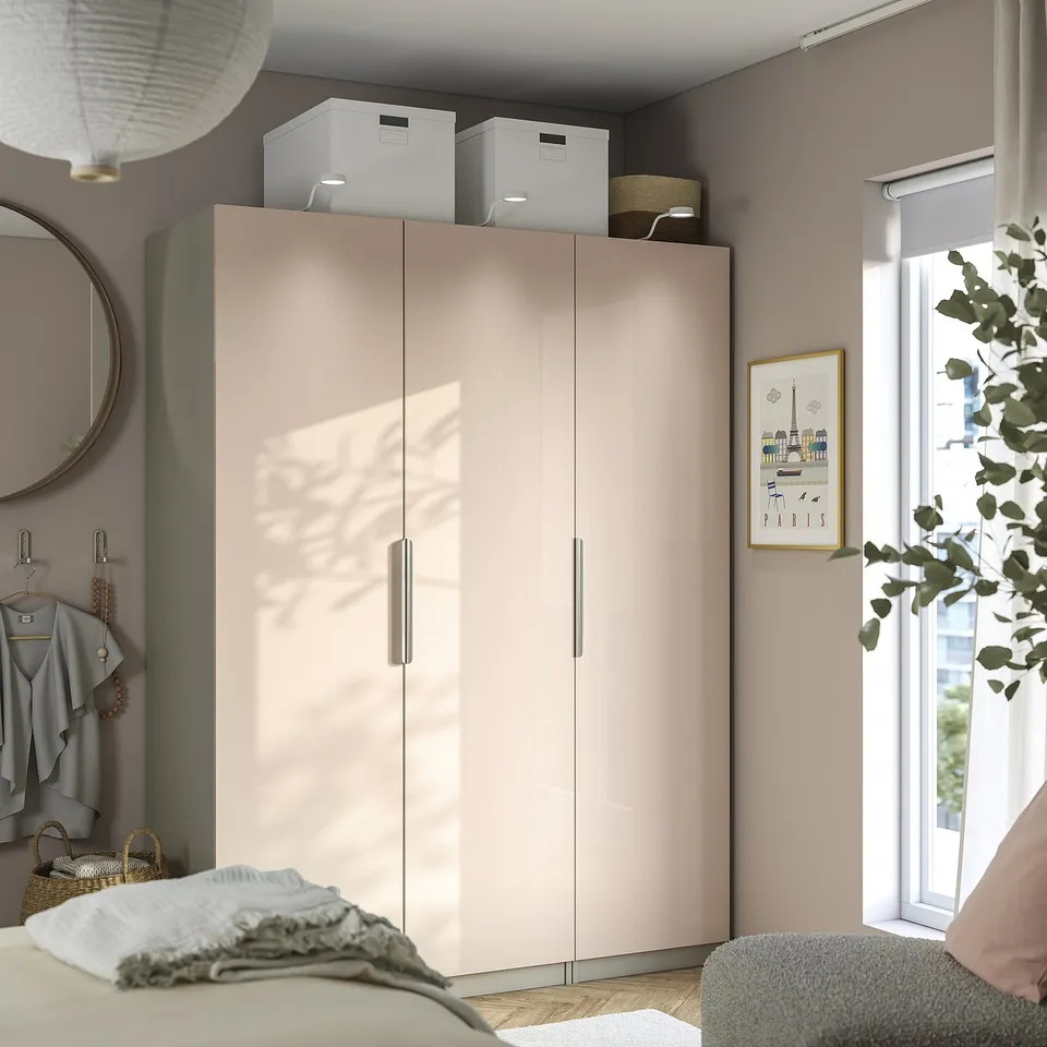 Modern bedroom with orange FARDAL wardrobe, glossy surfaces, & soft-close hinges.