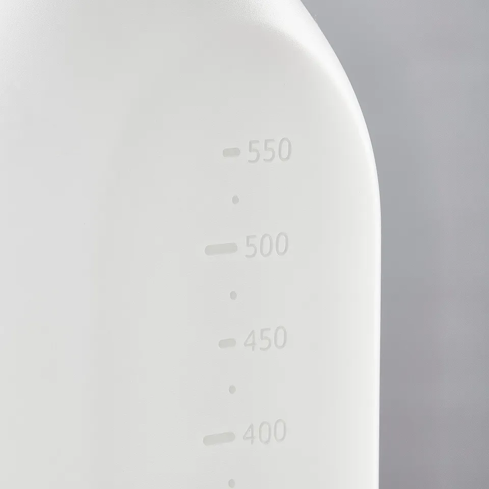 A white spray bottle with precise measurement markings: 400, 450, 500, 550 ml. Smooth, durable plastic texture.
