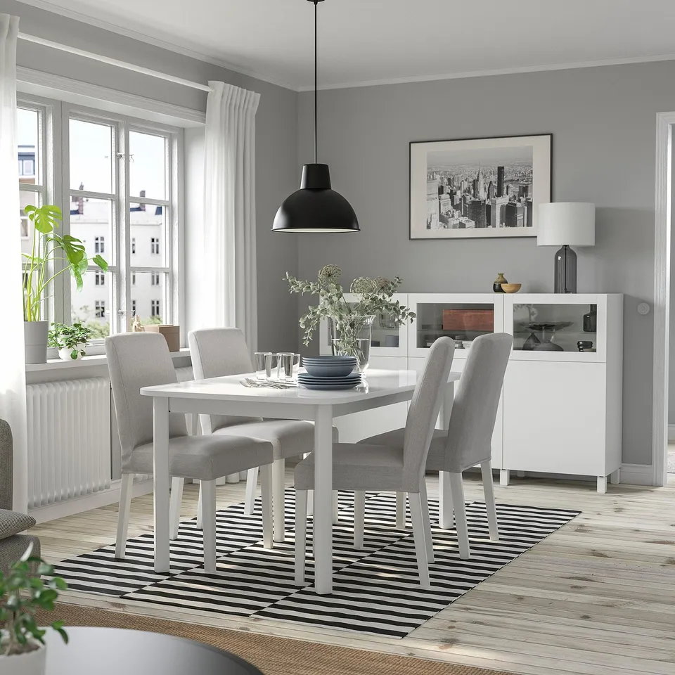 STRANDTORP white extendable dining table with grey chairs; modern, minimalist design; large for spacious room.