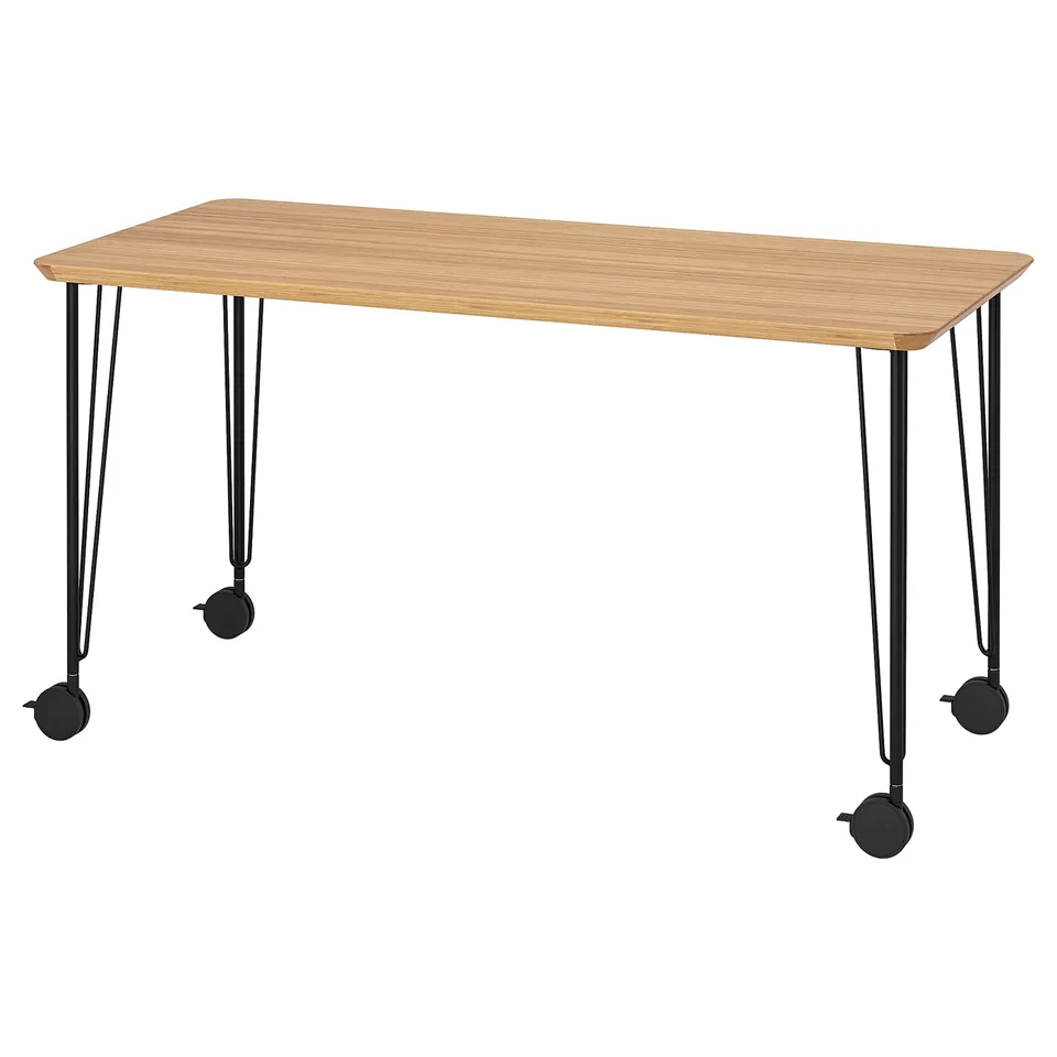 An anfalare desk with a wooden top and black metal legs featuring castors.