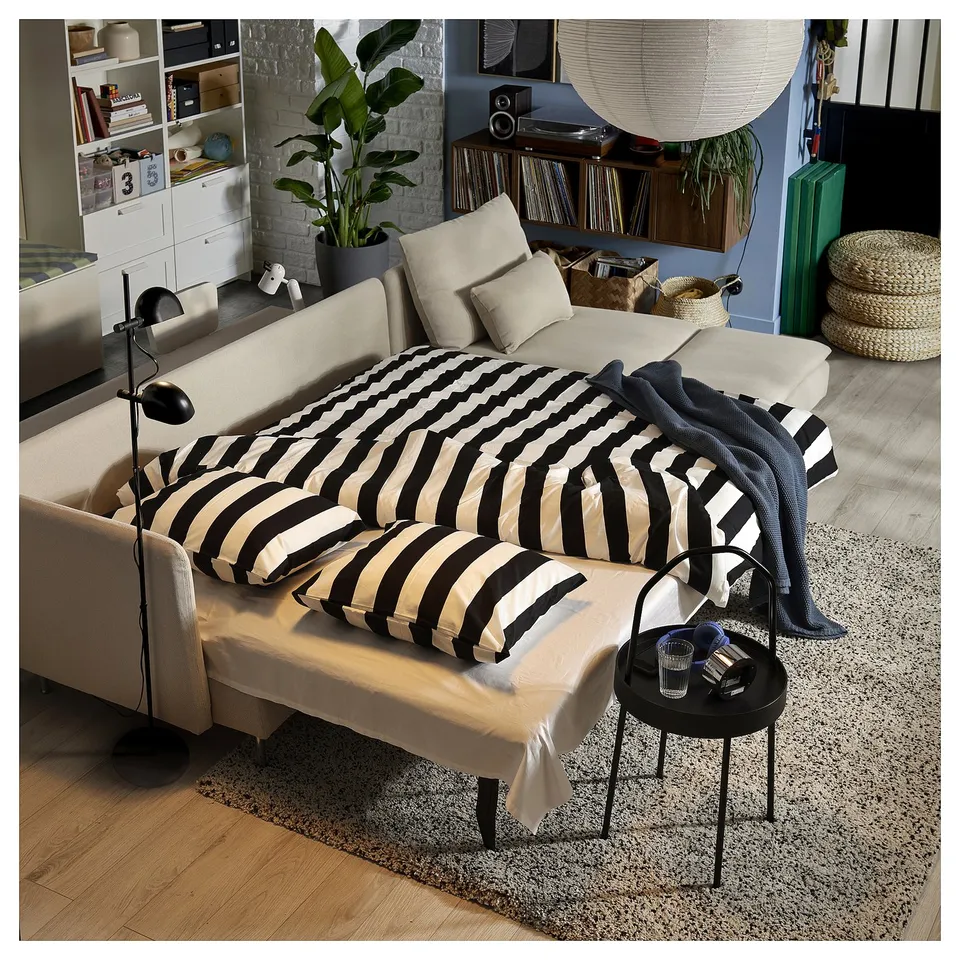 SÖDERHAMN sofa bed, living room. Beige, black/white cushions, converts to double bed, record player.