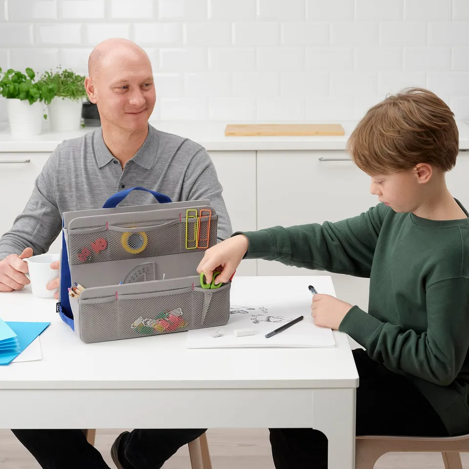 Person and child crafting with MÅLA supplies.