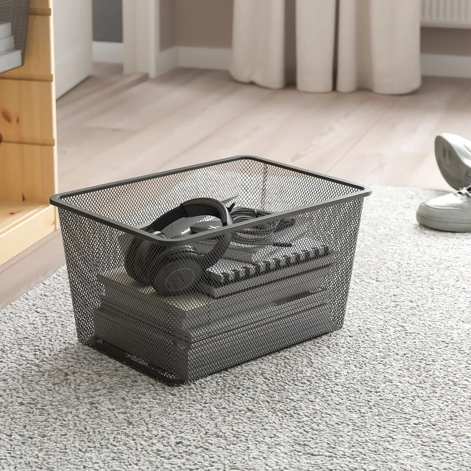 Mesh storage basket on carpet, perfect for organising items, fits in TROFAST frames.