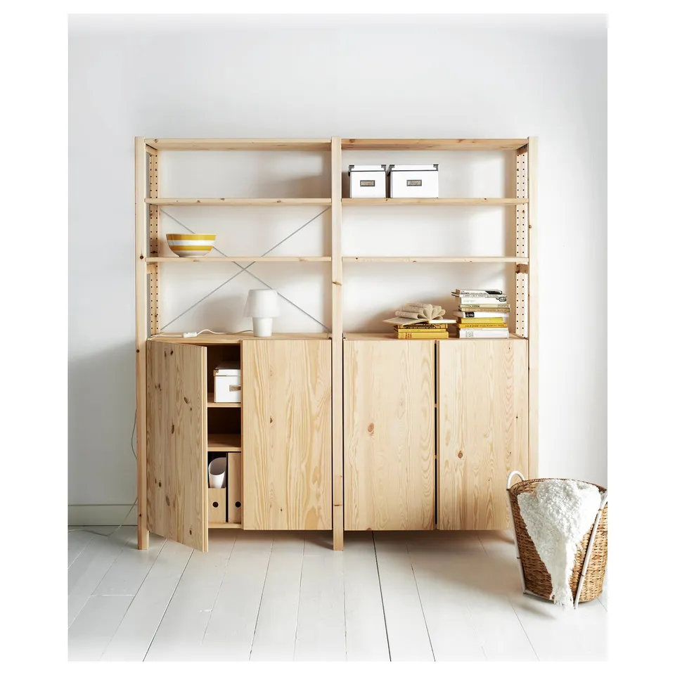 Wooden IVAR shelving unit with light-colored pine; cabinets and shelves with white decor.