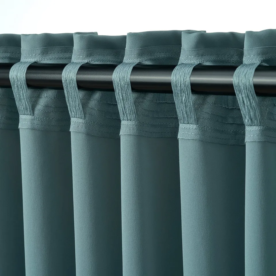 Turquoise curtains with pleats, gliders for privacy & light control.