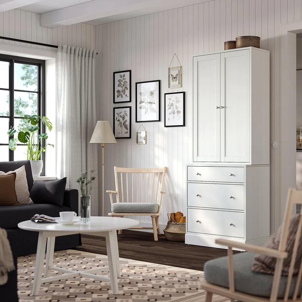 Scandinavian living room with HAVSTA cabinet, grey sofa, rocking chair, and warm rug.
