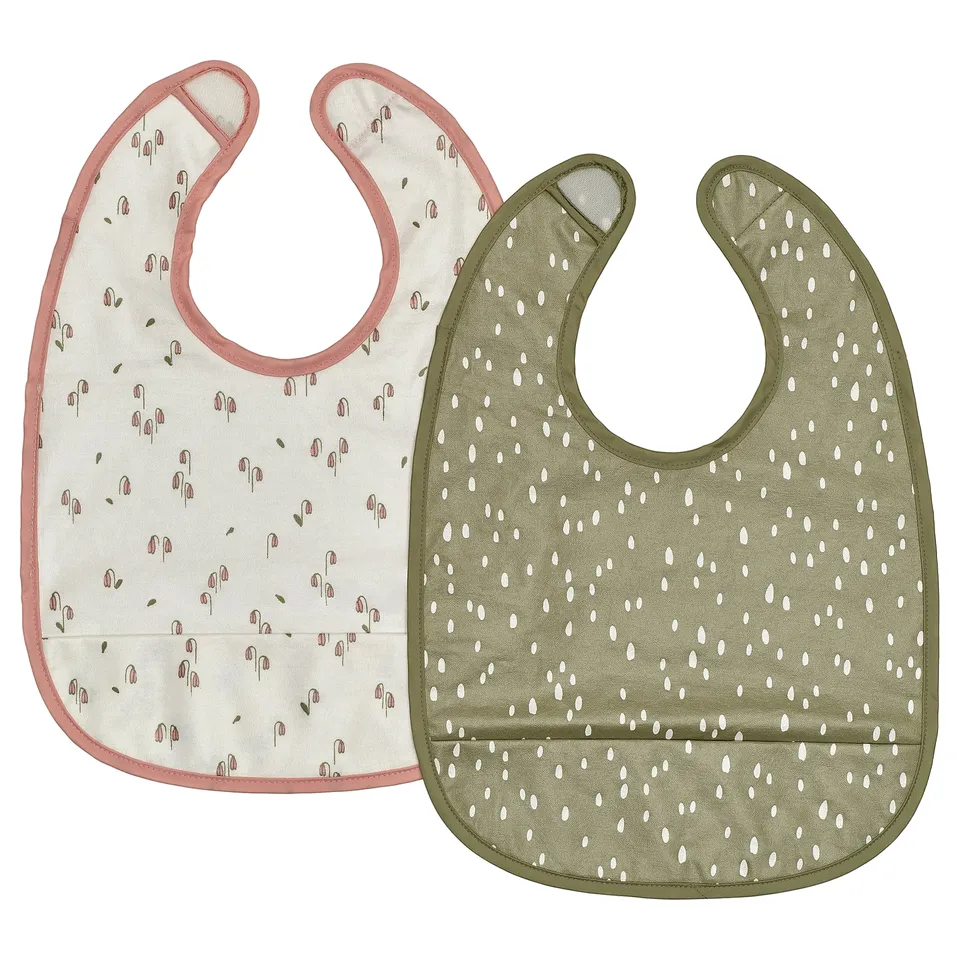 Two baby bibs: one white floral, one green dotted, rectangular with snap closure.