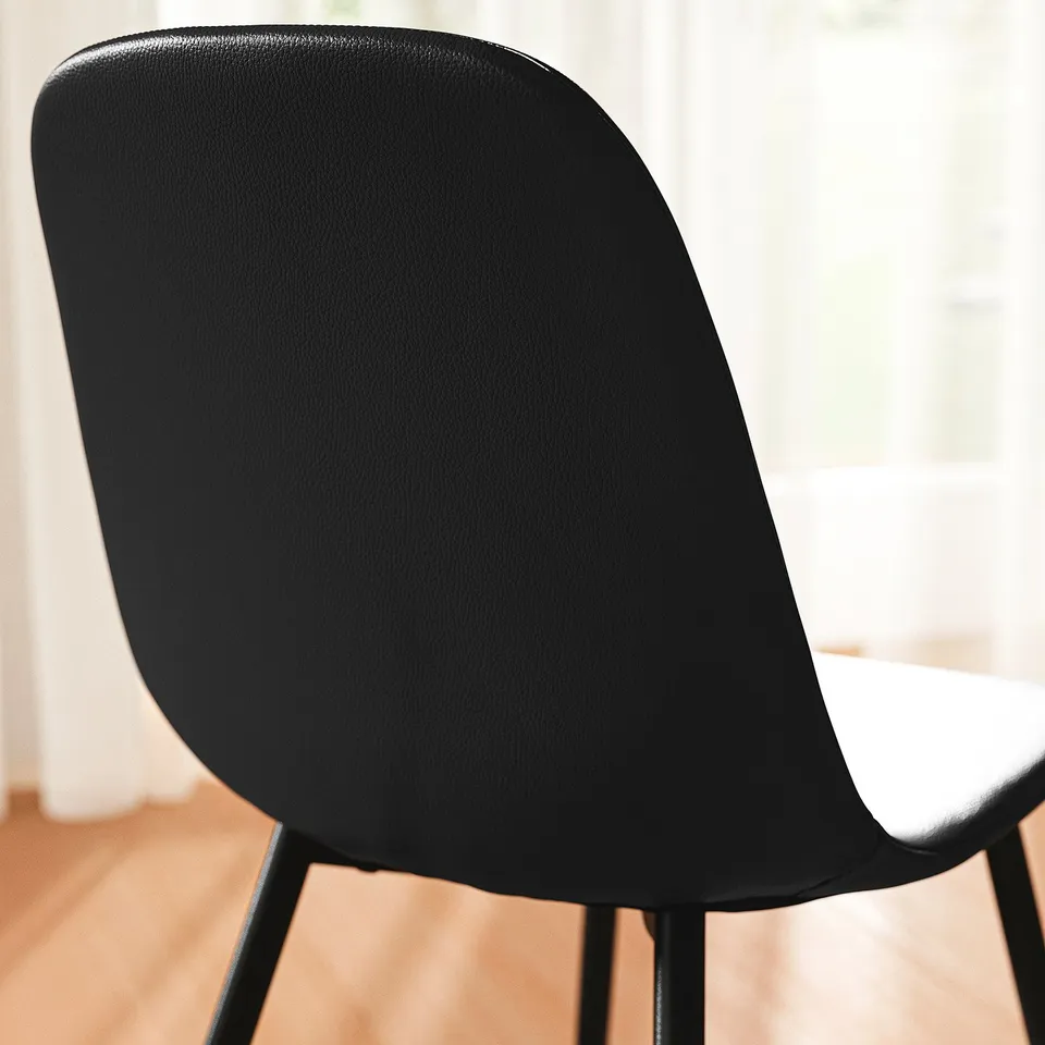 Black chair with cushioned seat and back, sleek design, sturdy metal legs, modern comfort.