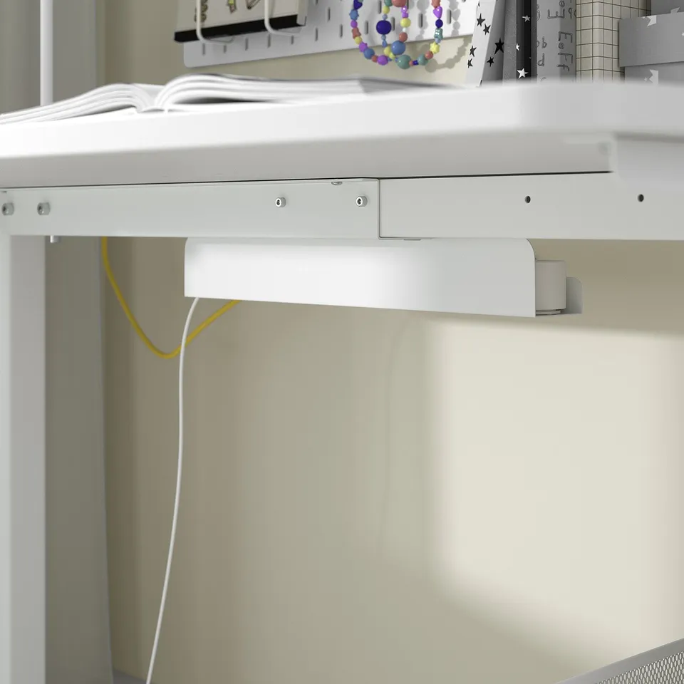 White desk with built-in shelf and cable management, designed for kids homework and crafts, featuring melamine surface and steel frame.