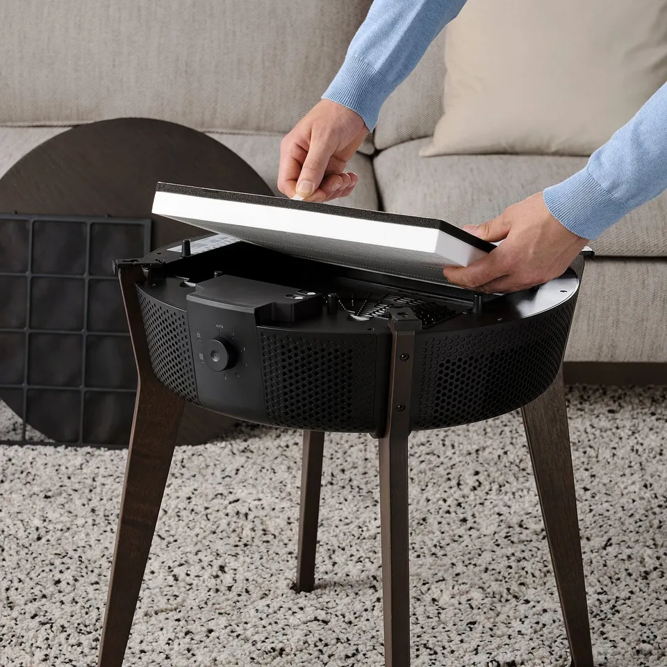 Person adjusting a modern side air purifier.