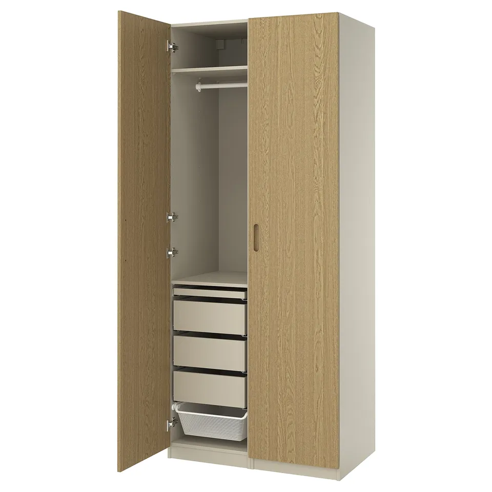 A light-colored PAX closet with the door open, featuring shelves and drawers.