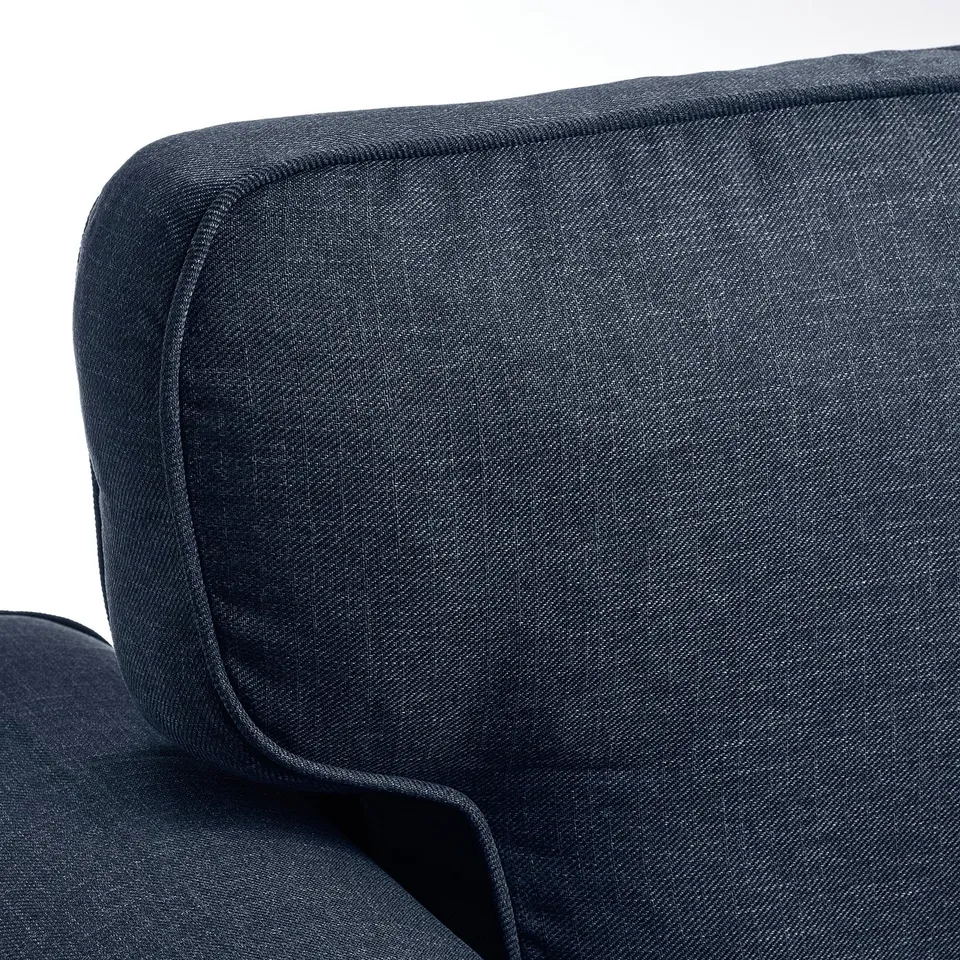 Dark blue, modern sofa showcasing high-quality upholstery. Clean lines and luxurious fabric, highlighting comfort and style.