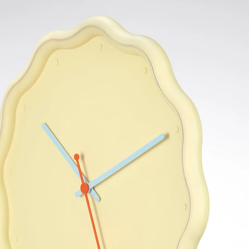 Unique clock with irregular shape, blue hands, orange centre axis, smooth texture.