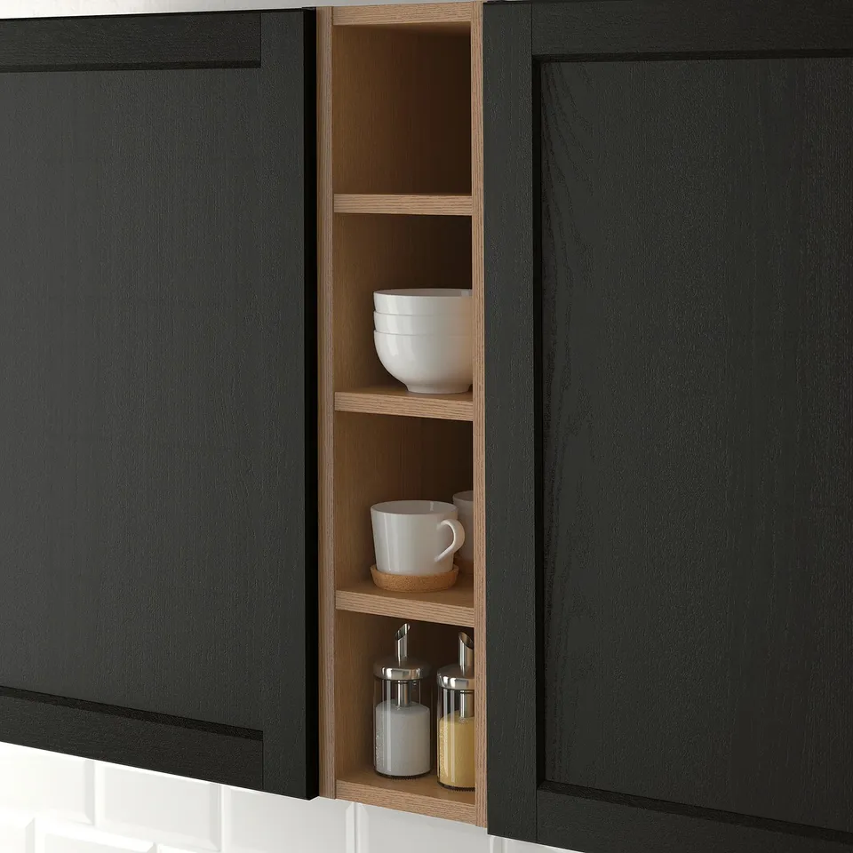 Open kitchen cabinet with wooden shelves, displaying white bowls, a mug, and spice jars, offering easy access and organisation.