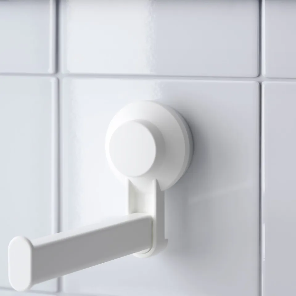 Yze white suction toilet paper holder securely mounts on tiled wall, robust plastic design.