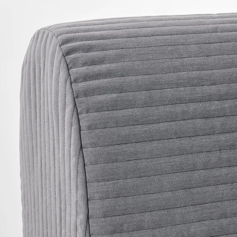 Close-up of stylish, modern sofa upholstered in textured, ribbed grey fabric, showcasing high-quality craftsmanship.