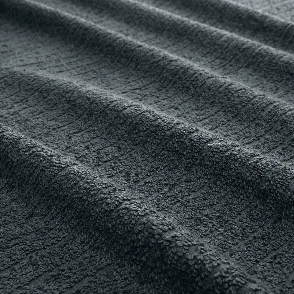 Close-up of soft, textured towels, showing quality terry and stripe patterns.
