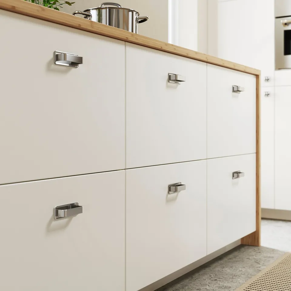 Modern kitchen with VEDDINGE white cabinets, sleek handle-less design, and wooden countertop.