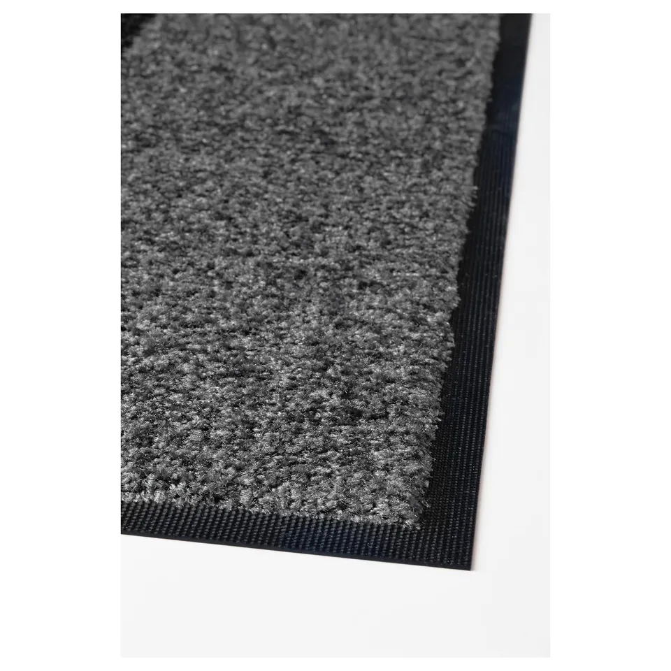 High-quality, durable grey door mat with textured surface and black edging, placed on white background.