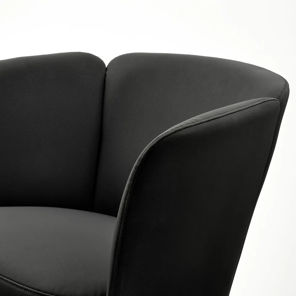Black upholstered chair with curved back and armrests, showcasing high-quality fabric and stitching.