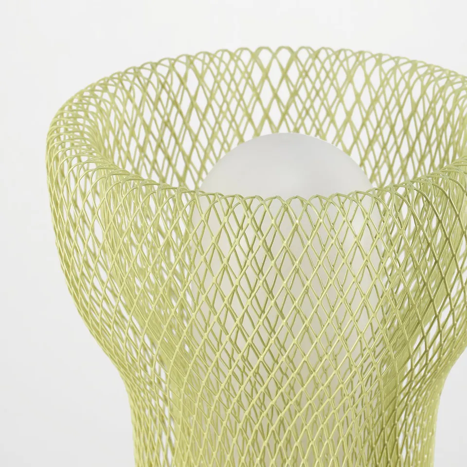 Modern green wire mesh table lamp, emitting soft light, ideal indoor/outdoor use.