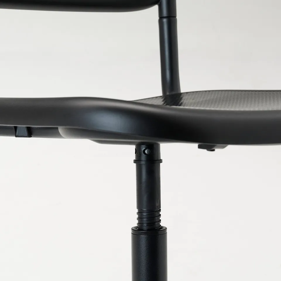 Black adjustable office chair with textured seat, shown from the side with height adjustment mechanism.