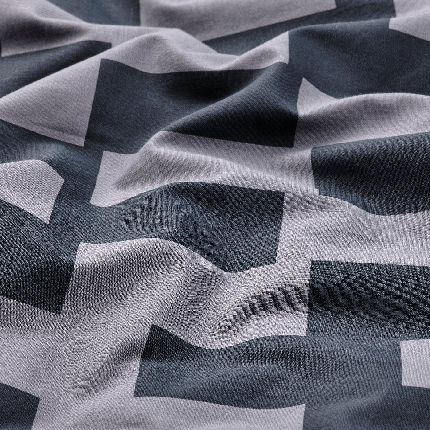 Duvet cover with geometric black and white pattern, made from soft cotton-viscose mix with a subtle sheen, ensuring comfort and breathability.
