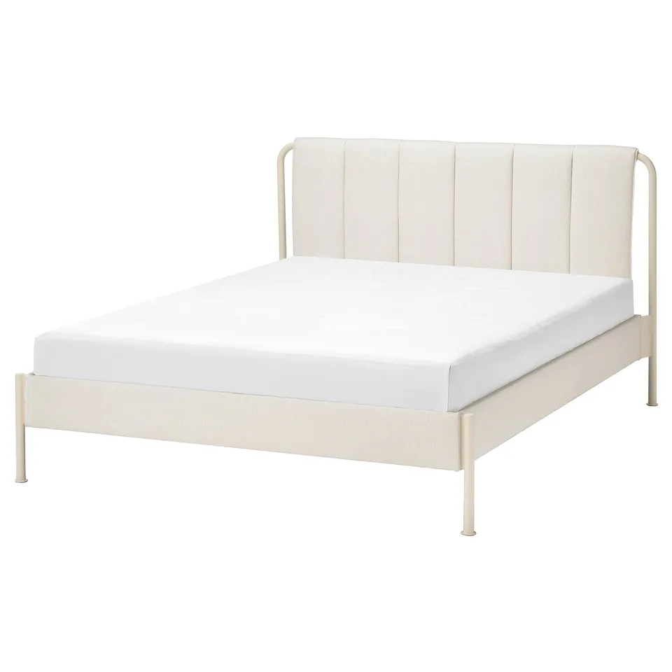 A TÄLLÅSEN bed in light beige with a padded headboard and metal frame. It has a modern design with clean lines and adjustable bed sides.