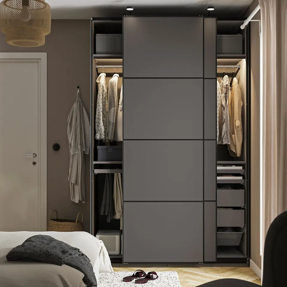 Cosy bedroom with a modern, deep PAX wardrobe featuring clothes hangers and shelves inside. The wardrobe has drawers and a closed section.