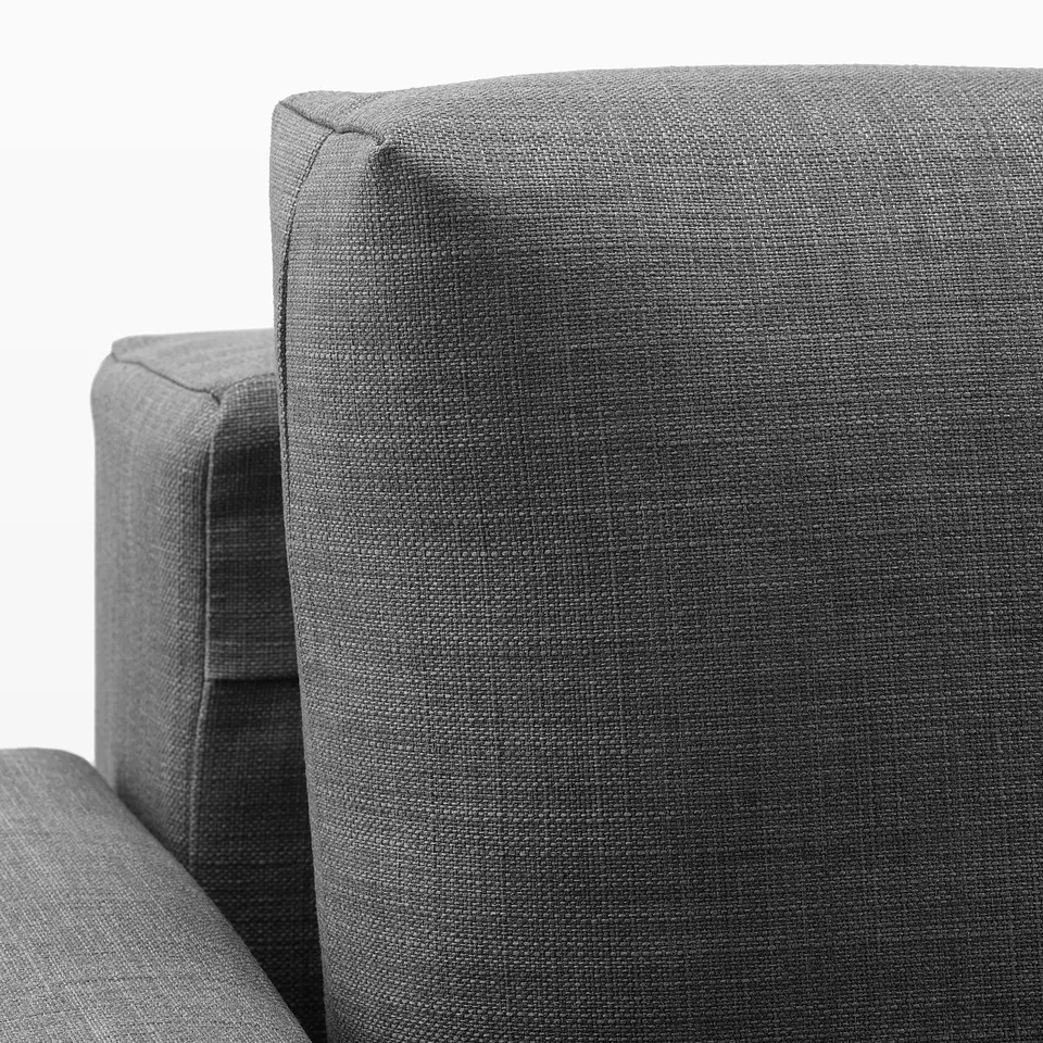 Close-up of FRIHETEN sofas sturdy, grey upholstery, showcasing quality fabric and robust stitching.