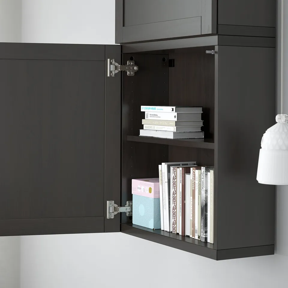 Open dark cabinet showing adjustable shelves filled with books.