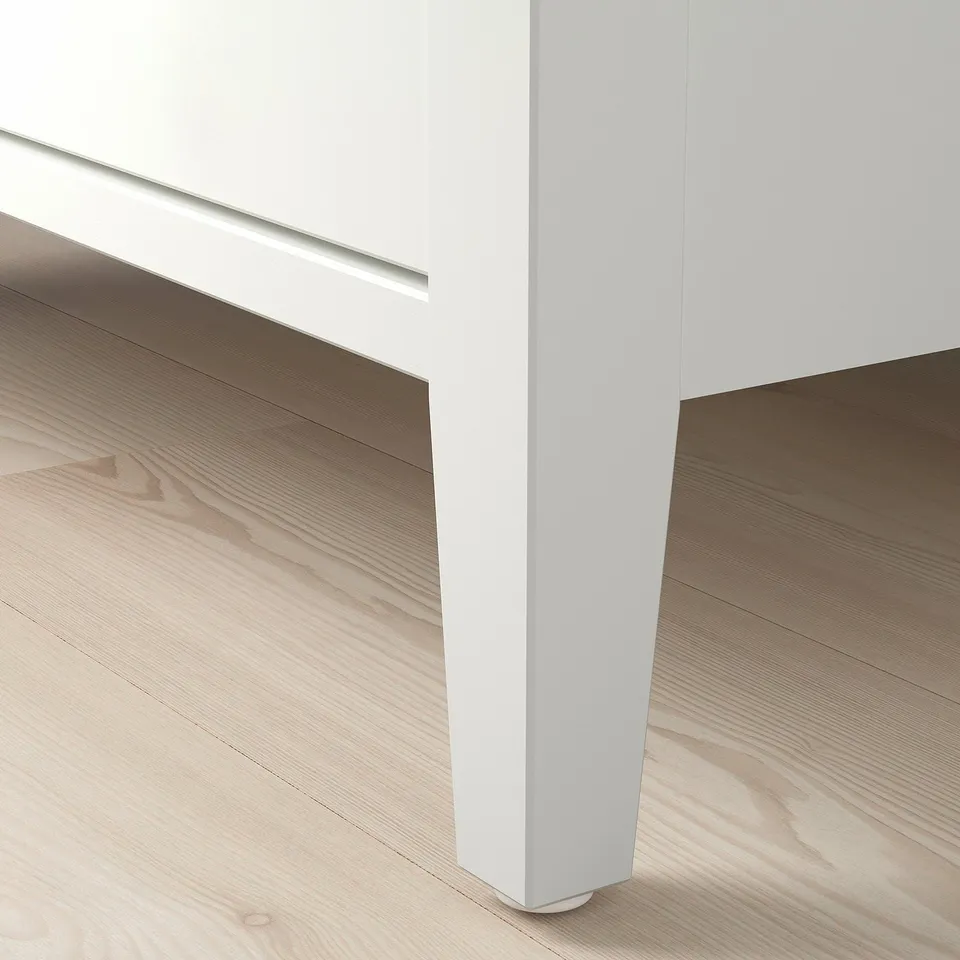 Modern coffee table with sleek white finish and glass top. Well-crafted design for durability and style.