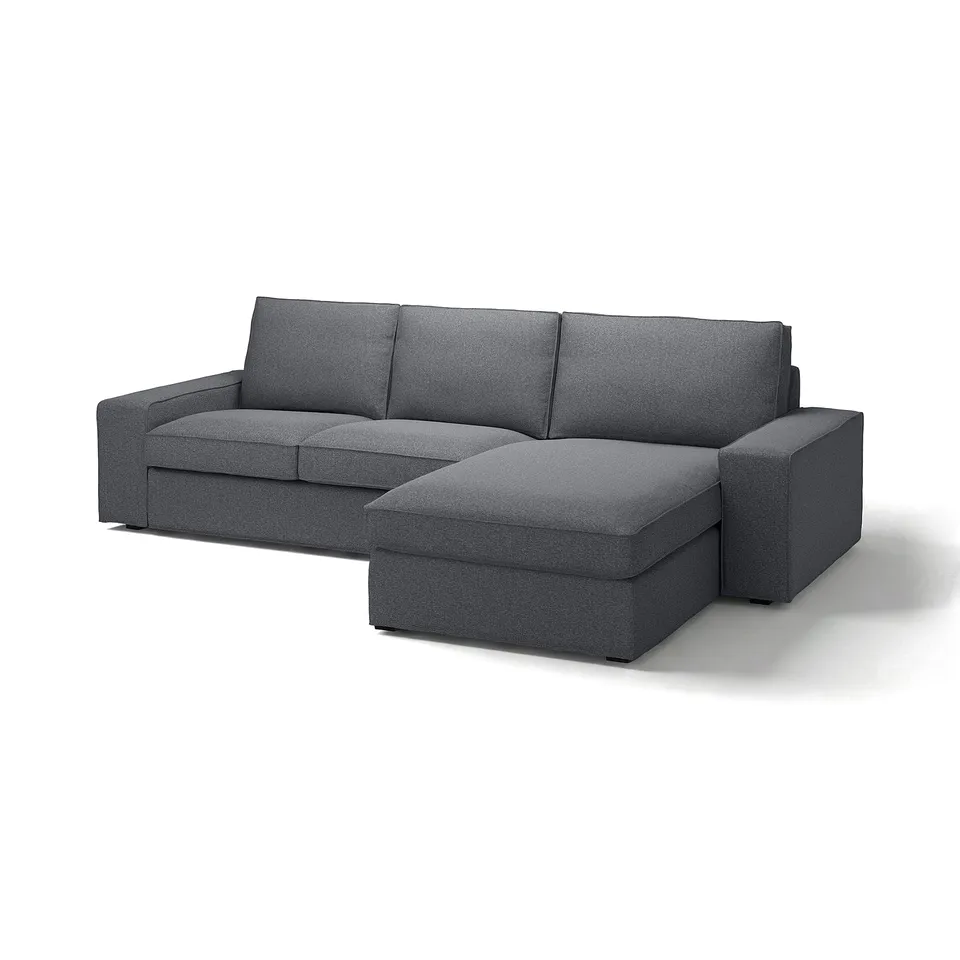 Modern grey sectional sofa with chaise, low armrests, and cosy cushions.