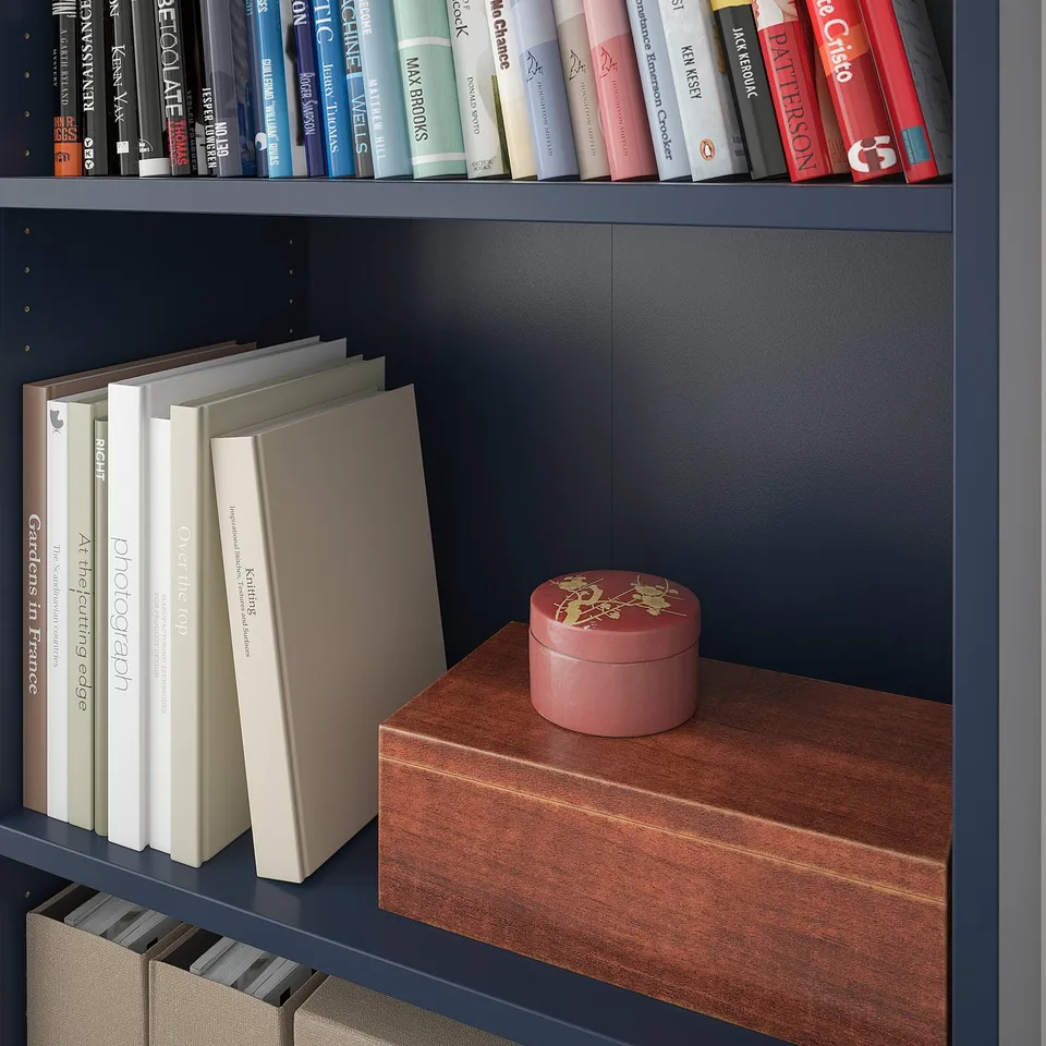 Bookshelf with wooden top, displaying books and a decorative box.