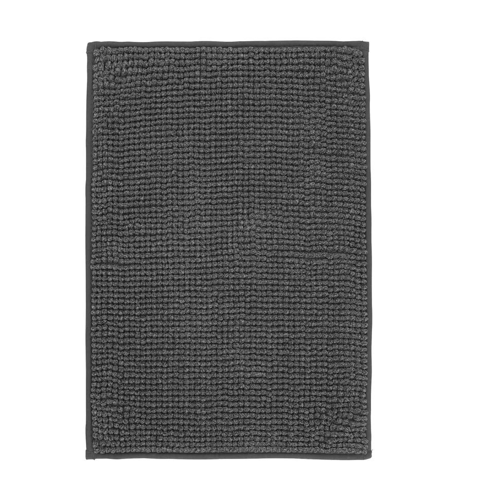 A dark grey TOFTBO bath mat. Its rectangular, soft, and textured, made from recycled polyester.