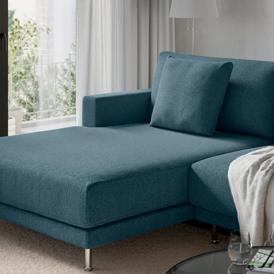 Teal sectional sofa with reclining seats, metal legs, by window.