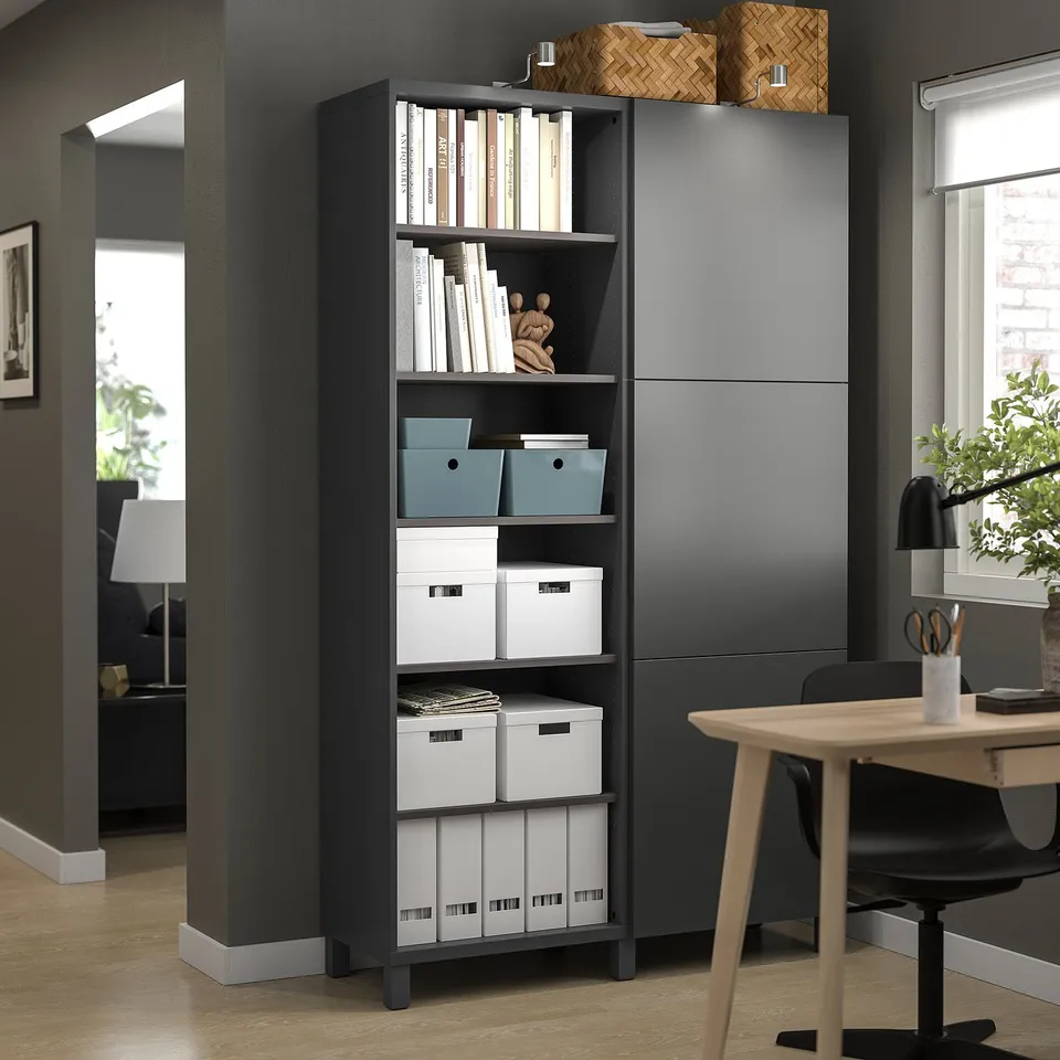 Modern home office with BESTÅ grey storage, shelves, desk, and black chair.