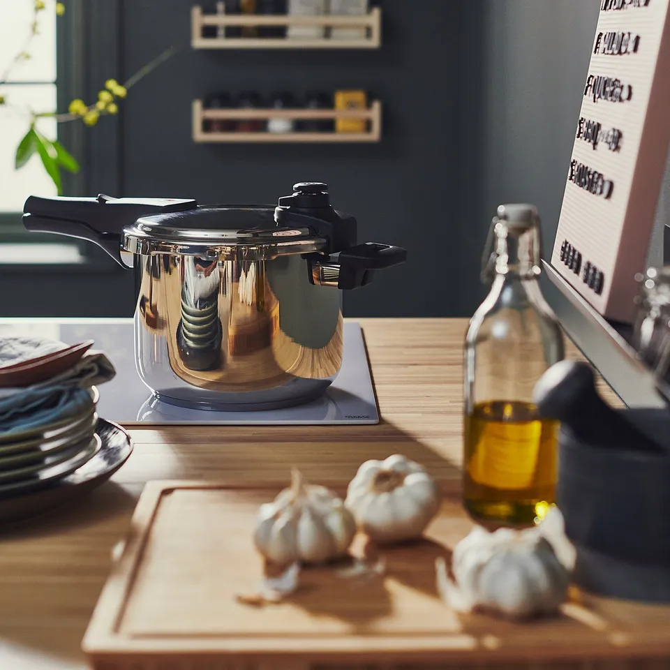 Modern kitchen counter with ikea pressure cooker and ingredients.