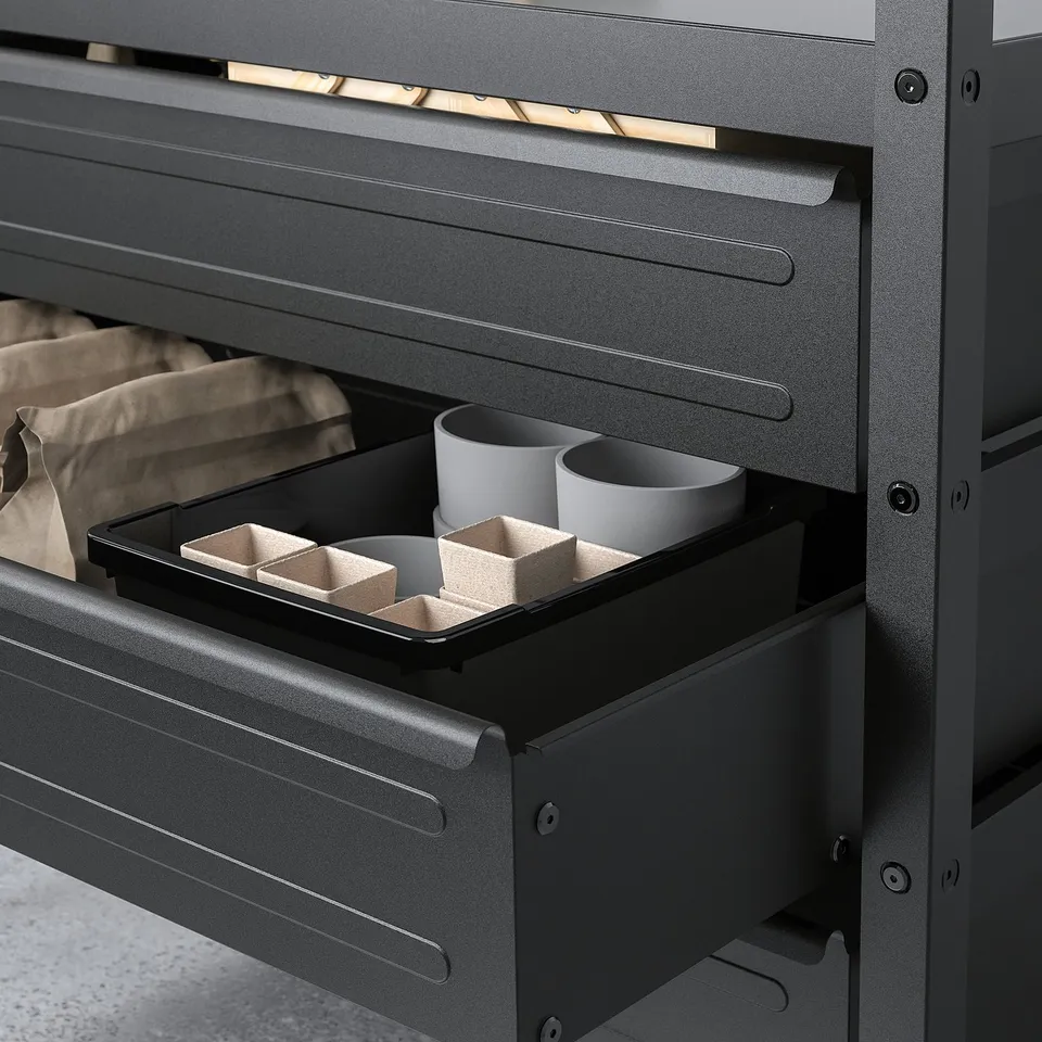 Black BROR drawer unit with open drawer showing cups and compartments, ideal for organised storage.
