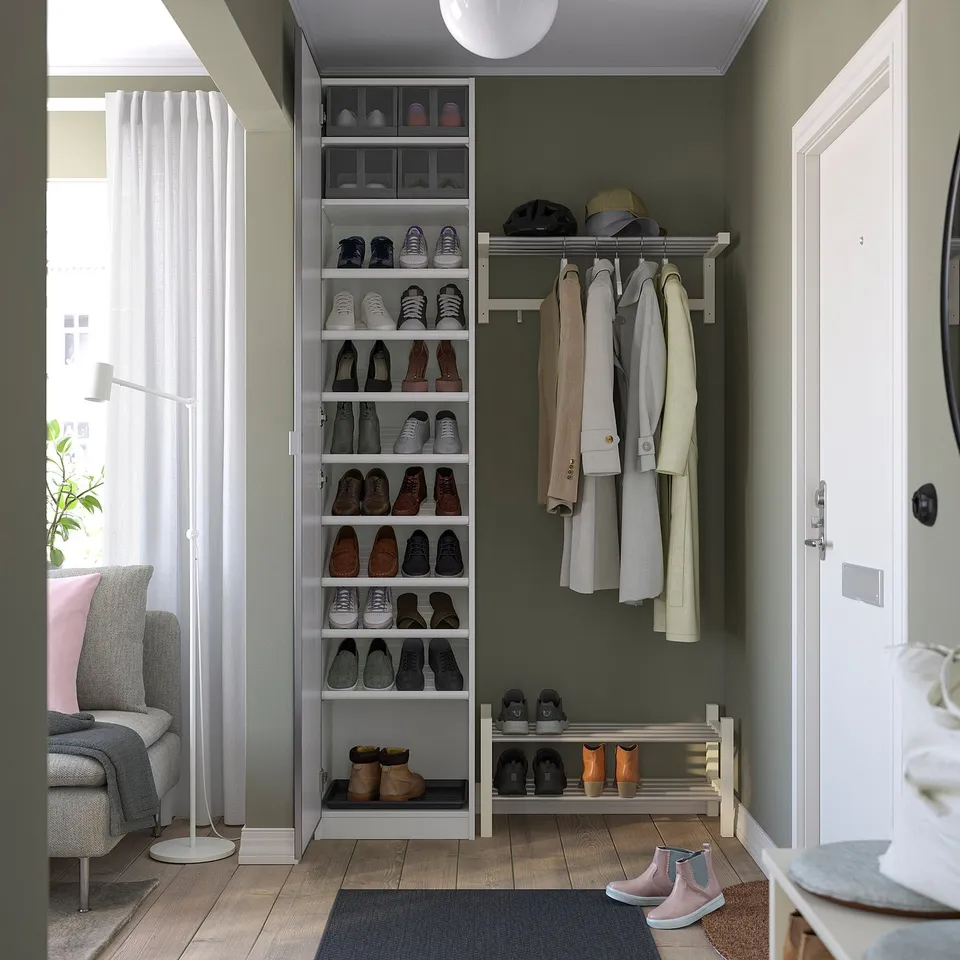 A modern entryway closet with a shoe rack, coat hooks, and shelves for organised storage.