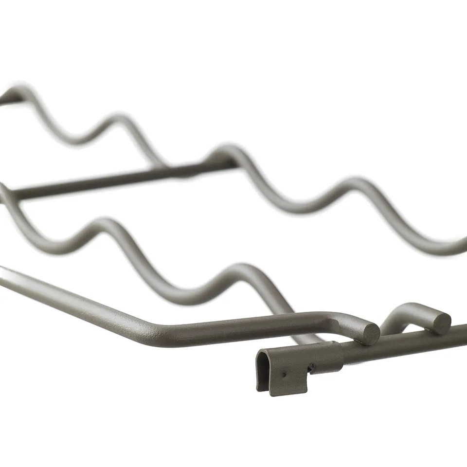 Close-up of three sturdy, metallic, wavy hooks on a storage system.