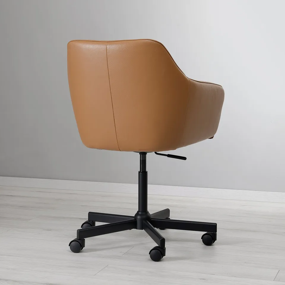 A brown leather swivel chair with soft padding and a high backrest. It has castors and is set against a grey wall.