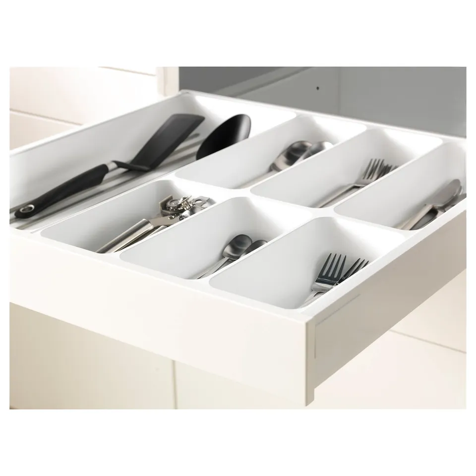 Kitchen drawer in white with multiple compartments neatly organising cutlery and utensils.